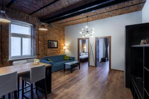 een woonkamer en eetkamer met een blauwe bank bij Apartamenty Centrum Częstochowa Stara Kamienica in Częstochowa