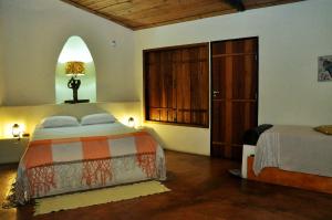 a bedroom with a bed and a closet with a door at Salto Corumbá Hotel Camping Clube in Corumbá de Goiás +30 photos