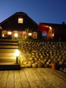 eine Steinmauer vor einem Haus in der Nacht in der Unterkunft Das GrachtenDOMiZiL Greetsiel in Greetsiel