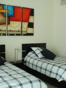 A bed or beds in a room at Departamento de Lujo