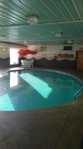 a large swimming pool in a building at Baymont by Wyndham Indianapolis Northeast in Indianapolis