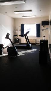 an empty room with a gym with a treadmill at Baymont by Wyndham Indianapolis Northeast in Indianapolis