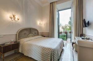 a bedroom with a bed and a large window at Rome Charming Suites in Rome