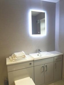 a bathroom with a sink and a mirror at The Studio in Ingoldmells