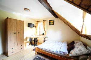 a bedroom with a bed and a stair case at Przystań Jaskółka in Ruciane-Nida