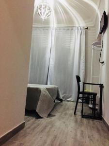 a room with a table and a chair and a window at Richbaby in Rome