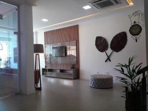 a living room with a feather wall art and a mirror at Hotel Sempre Executive in Salvador
