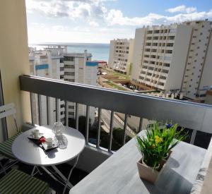 a balcony with a table and a view of the ocean at Tarik Moments Apartment in Portimão