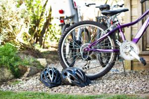 a purple bike parked next to helmets on the ground at Gwithian Holidays in Hayle