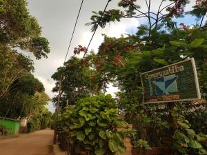 a sign for a garden shop with plants at Pousada Mayon in Cumuruxatiba