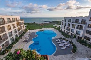 an aerial view of a resort with a pool and chairs at Studio in Diamond Beach in Burgas