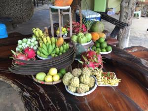 a display of fruits and vegetables in bowls on a table at Ok Farm Resort in Det Udom