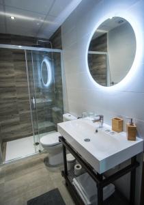 a bathroom with a sink, toilet and bathtub at The Lights Suites in Málaga