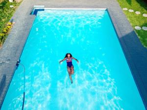 a woman swimming in a swimming pool at Rekky Signature Guesthouse in Johannesburg