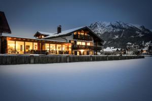 a large house with snow in front of it at Louisa in Oberstdorf