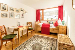 a bedroom with a bed and a desk and a window at Louisa in Oberstdorf