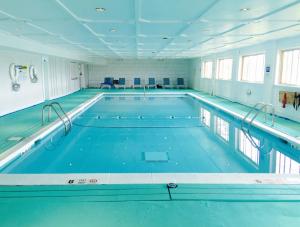 a large indoor swimming pool with blue water at Ocean Vista Resort in Amagansett
