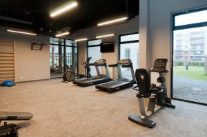 a gym with a bunch of exercise equipment in a room at AquaBaltic in Kołobrzeg
