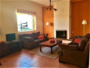 a living room with two couches and a table at Demetras' house in Nafplio