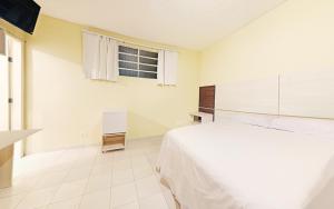 Postel nebo postele na pokoji v ubytování Hotel Curitiba Campo Comprido