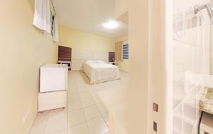 Postel nebo postele na pokoji v ubytování Hotel Curitiba Campo Comprido