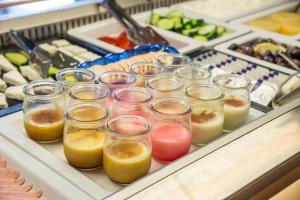 a bunch of glasses filled with different types of juice at Kordistos Hotel in Kefalos