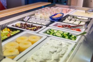 a refrigerator filled with lots of different types of food at Kordistos Hotel in Kefalos