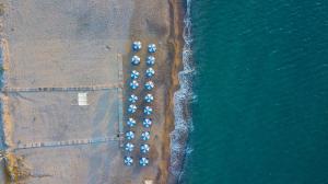 an overhead view of a beach with a group of parked cars at Kordistos Hotel in Kefalos