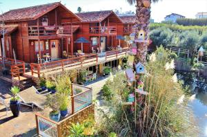 an aerial view of a log house with a lake at Villa Ana Margarida by Nature in Ericeira