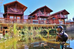 a resort with a statue in front of a pond at Villa Ana Margarida by Nature in Ericeira