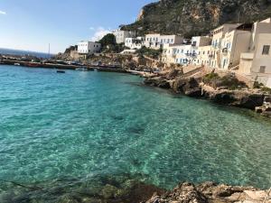 a view of a beach with buildings and the water at Mare E Timo in Marettimo