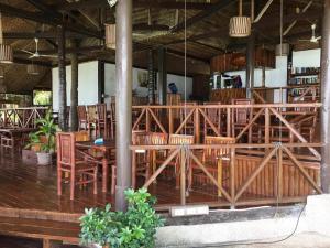 a dining room with wooden tables and chairs at Allba's Homestay in Moalboal