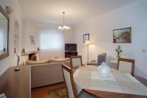 a living room with a table and a couch at Apartamento da Estação in Monção