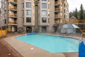 a large swimming pool in front of a apartment building at Marquise by Whistler Blackcomb Vacation Rentals in Whistler