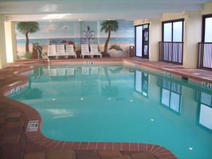 a large swimming pool in a hotel with chairs in it at Sea Crest Oceanfront Resort in Myrtle Beach