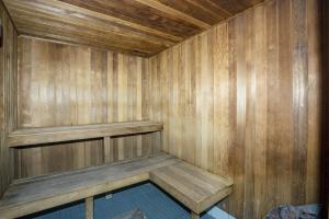 a wooden sauna with a bench in a room at Surfers Aquarius on the Beach in Gold Coast