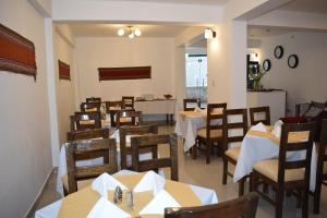 a dining room with tables and chairs in a restaurant at Mantu Boutique in Machu Picchu