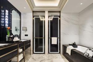 a bathroom with a tub and a sink at Bellagio by MGM Shanghai - on the bund in Shanghai