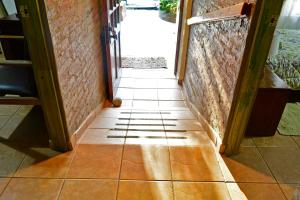 a hallway with a tiled floor in a building at Casa Camelia in Rinconada de los Andes