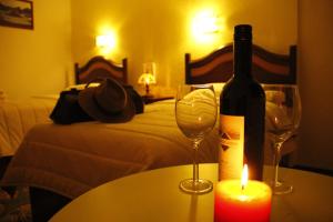 a bottle of wine and a candle on a table at Hotel San Felipe el Real in San Felipe +46 photos