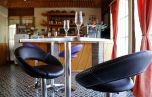 a bar with two wine glasses on a table at Hotel San Felipe el Real in San Felipe
