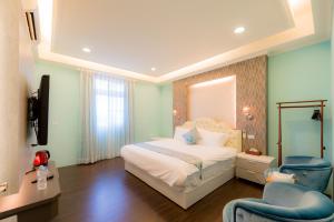Säng eller sängar i ett rum på Taitung Quality B&B