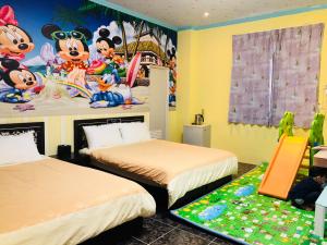 志學村的住宿－吾居吾宿，一间卧室配有两张床和一张麦克奇老鼠壁画