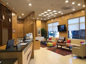 a lobby of a hotel with couches and tables at Ramada by Wyndham Dongtan in Hwaseong