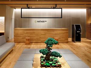 a bonsai tree sitting on a table in a lobby at HATAGO INN Shizuoka Yoshida IC in Shimada