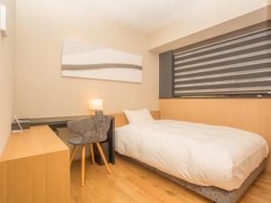 Postel nebo postele na pokoji v ubytování HATAGO INN Shizuoka Yoshida IC