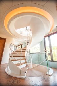 a spiral staircase in a room with windows at Dreamer Boutique Hotel in Nanwan
