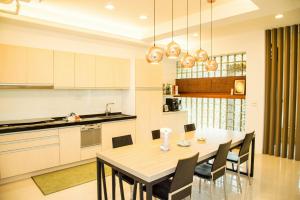 a kitchen and dining room with a table and chairs at Mountain Homestay 6-8人包棟民宿 in Xinhua