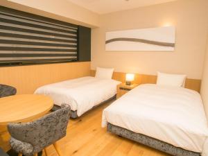 Postel nebo postele na pokoji v ubytování HATAGO INN Shizuoka Yoshida IC