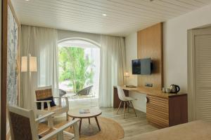 A television and/or entertainment centre at Canonnier Beachcomber Golf Resort & Spa